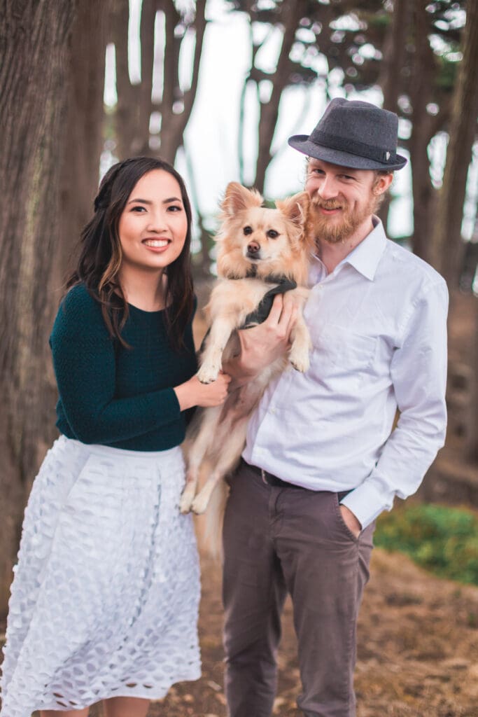 Couple with their dog enjoying a photoshoot, captured in a natural and candid moment by a San Francisco Bay Area wedding photographer.