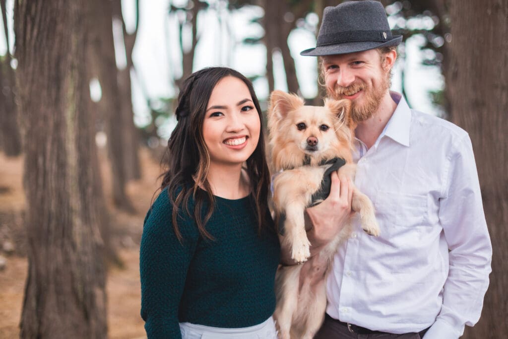 Couple with their dog enjoying a photoshoot, captured in a natural and candid moment by a San Francisco Bay Area wedding photographer.