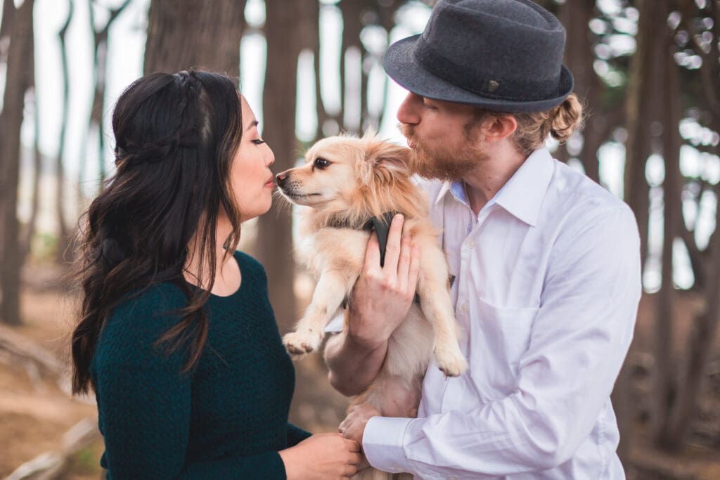 Couple with their dog enjoying a photoshoot, captured in a natural and candid moment by a San Francisco Bay Area wedding photographer.