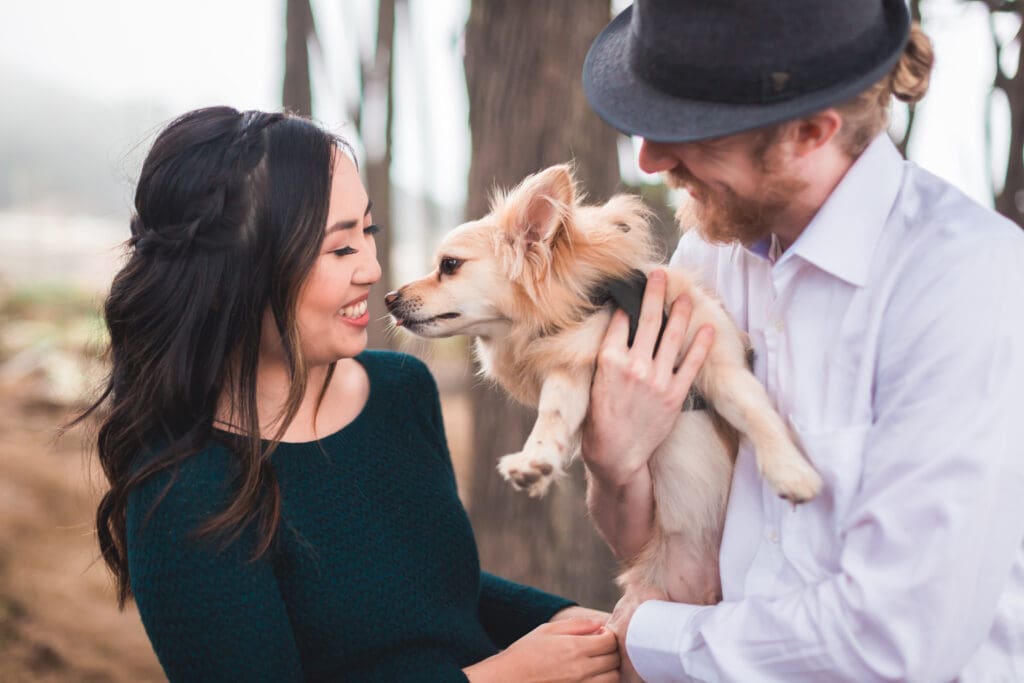 Couple with their dog enjoying a photoshoot, captured in a natural and candid moment by a San Francisco Bay Area wedding photographer.
