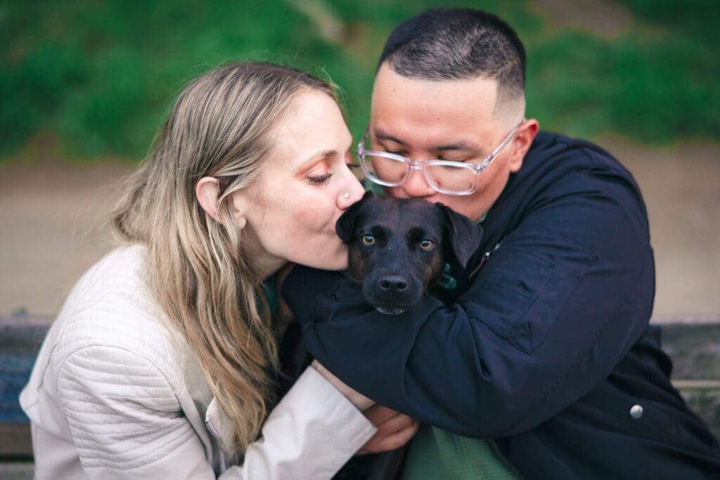 Couple with their dog enjoying a photoshoot, captured in a natural and candid moment by a San Francisco Bay Area wedding photographer.